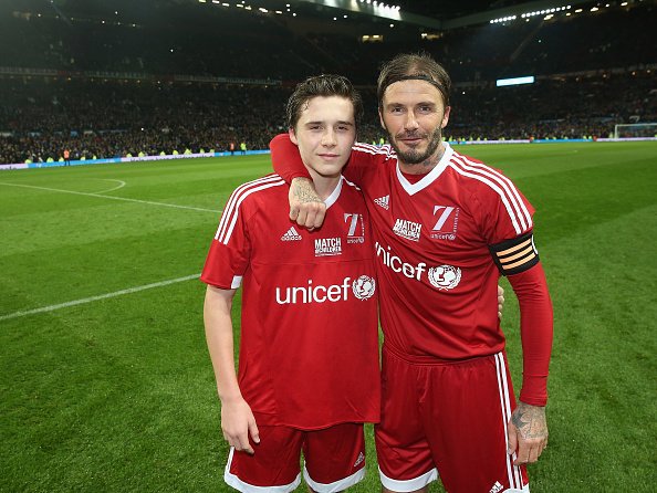 MANCHESTER, ENGLAND - NOVEMBER 14: David Beckham of Great Britain and Ireland poses with his son Brooklyn Beckham after the David Beckham Match for Children in aid of UNICEF between Great Britain and Ireland and the Rest of the World at Old Trafford on November 14, 2015 in Manchester, England. (Photo by John Peters/Man Utd via Getty Images)