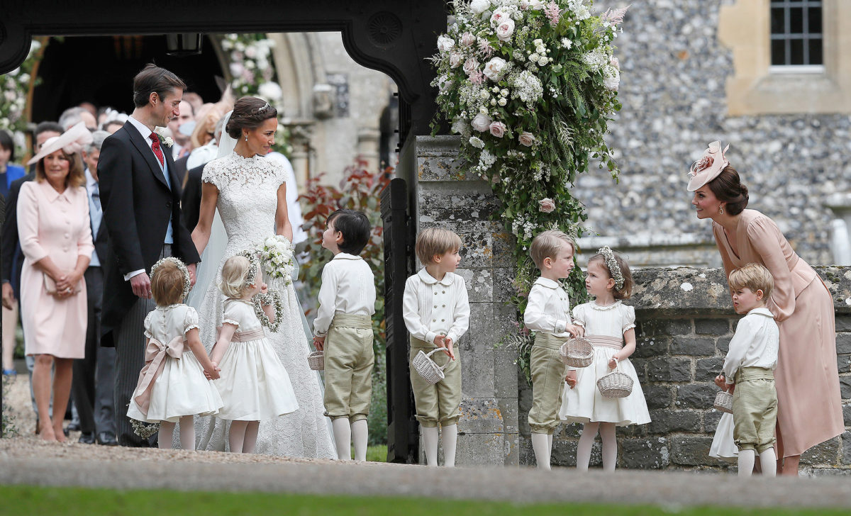 Kate, Duchess of Cambridge, right, stands with her son Prince George as she looks across at Pippa Middleton and James Matthews after their wedding at St Mark's Church in Englefield, England Saturday, May 20, 2017. Middleton, the sister of Kate, Duchess of Cambridge married hedge fund manager James Matthews in a ceremony Saturday where her niece and nephew Prince George and Princess Charlotte was in the wedding party, along with sister Kate and princes Harry and William. (AP Photo/Kirsty Wigglesworth, Pool)