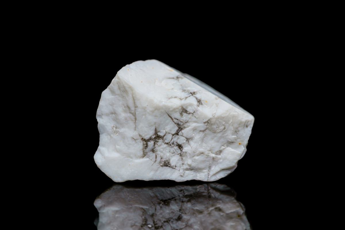 白松石多呈帶灰黑天然紋理的白色調、外觀像大理石，但因質地較軟且多孔，日常佩戴要避免碰撞與接觸化學品。