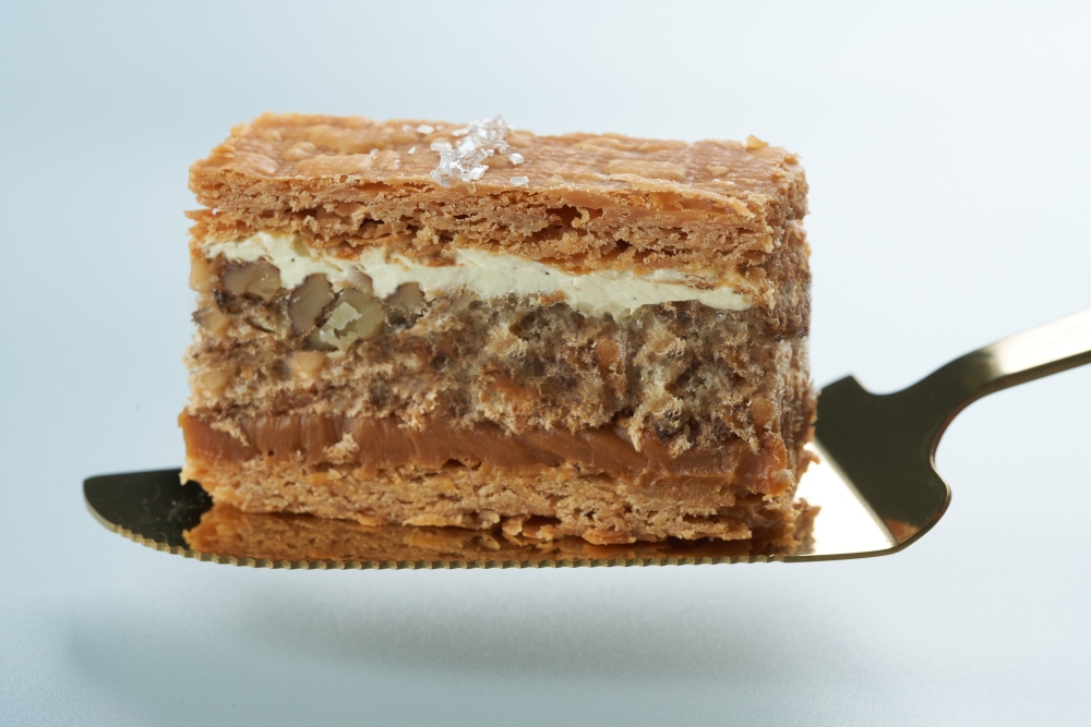 每日早上6時開始,堅持以全人手製作合桃千層餅,單是中間的一層合桃蛋白餅,便要花4小時焗製,製作工序繁複,而且極花心機。