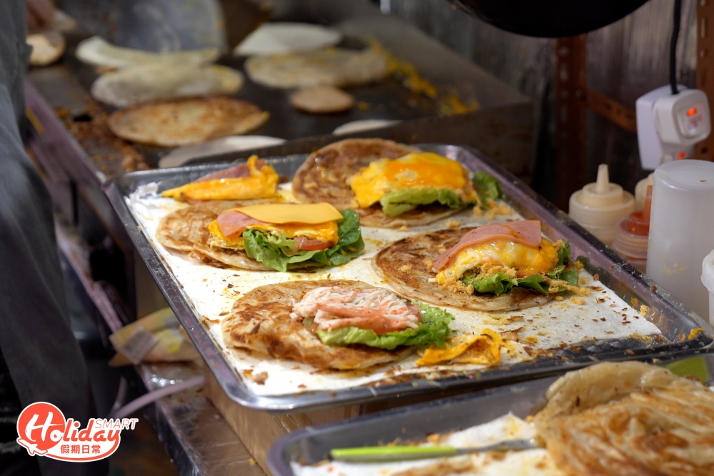 眾多口味選擇中，招牌「火腿雞蛋芝士豬柳手抓餅」和「火腿雞蛋肉鬆手抓餅」最受歡迎，前者感覺似手抓餅版的芝士豬柳蛋漢堡，半融芝士配上漢堡扒、蕃茄和生菜等夠惹味；後者火腿和雞蛋煎得香口，配上海量肉鬆，口感層次豐富。