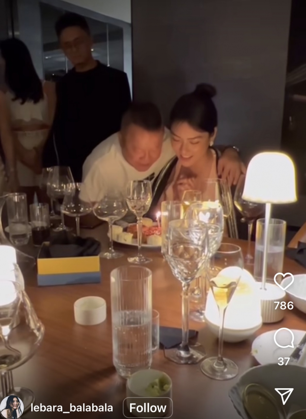 曾志偉一手搭上黎峇菈膊頭,同佢一齊吹蠟燭