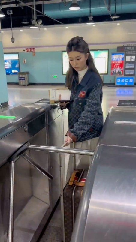 Janice拖行李箱拍卡入站。